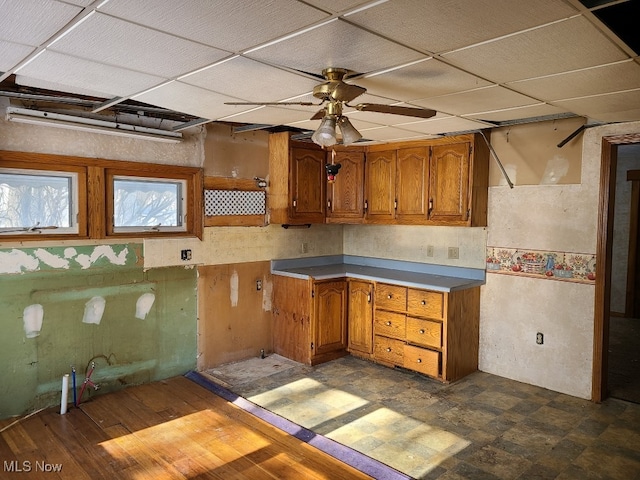 kitchen with ceiling fan and a drop ceiling