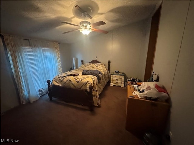 bedroom featuring a textured ceiling, ceiling fan, and carpet flooring