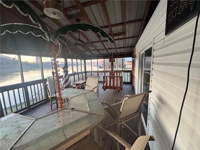 wooden terrace with ceiling fan and a water view