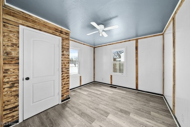 unfurnished bedroom with ceiling fan and light hardwood / wood-style floors