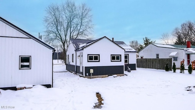 view of snow covered back of property