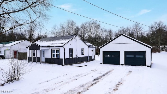 view of snow covered exterior with a garage