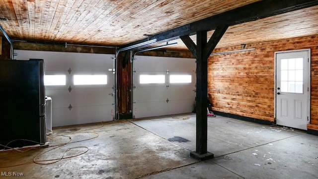 garage with wooden ceiling and stainless steel fridge