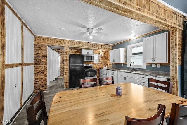 kitchen featuring ceiling fan, appliances with stainless steel finishes, crown molding, white cabinets, and sink