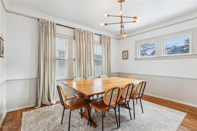 dining room with wood-type flooring and a chandelier