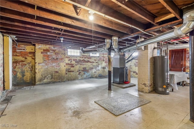 basement featuring gas water heater, sink, and heating unit