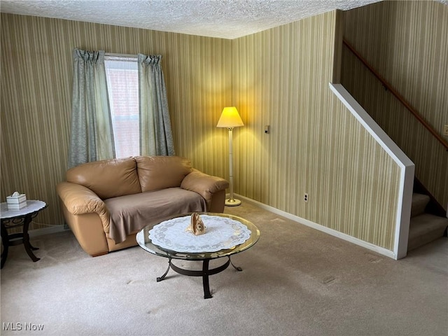 living area with a textured ceiling and carpet flooring