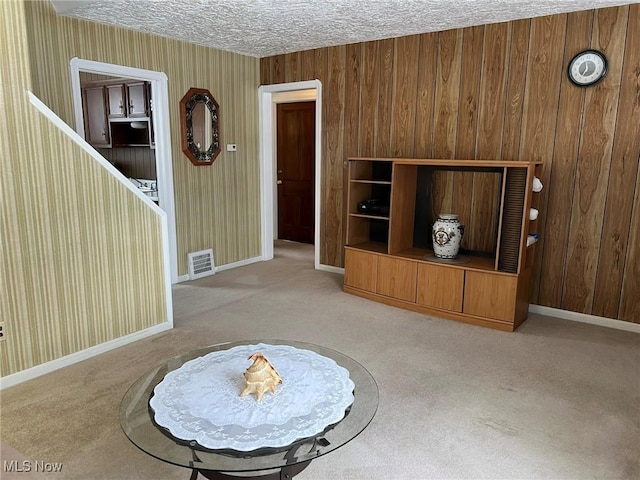 living room featuring carpet flooring and a textured ceiling