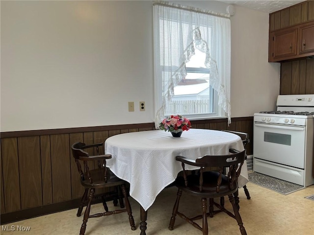 dining room featuring wooden walls