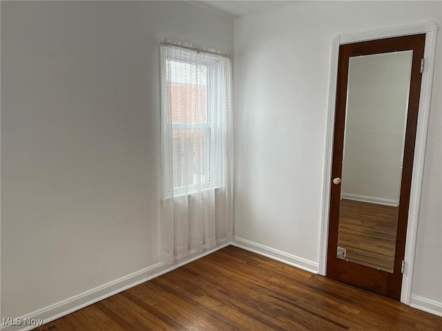 empty room with dark wood-type flooring