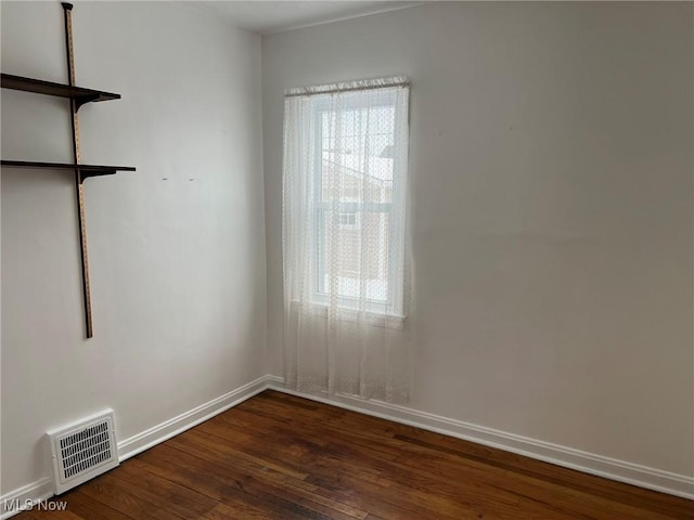 unfurnished room with dark hardwood / wood-style floors