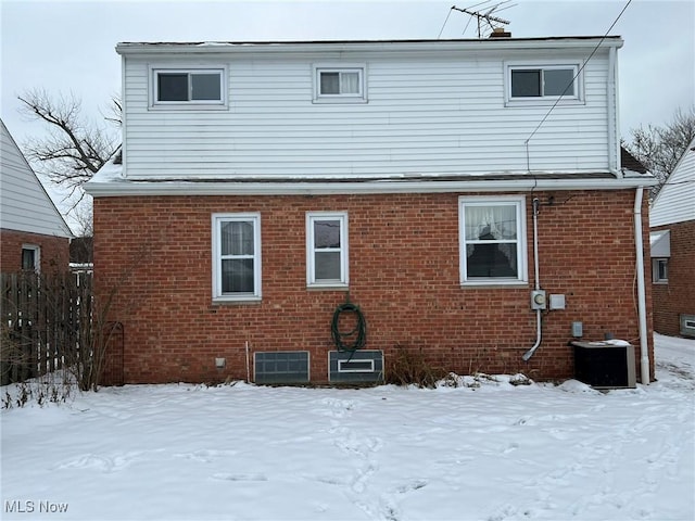 snow covered house with central AC unit