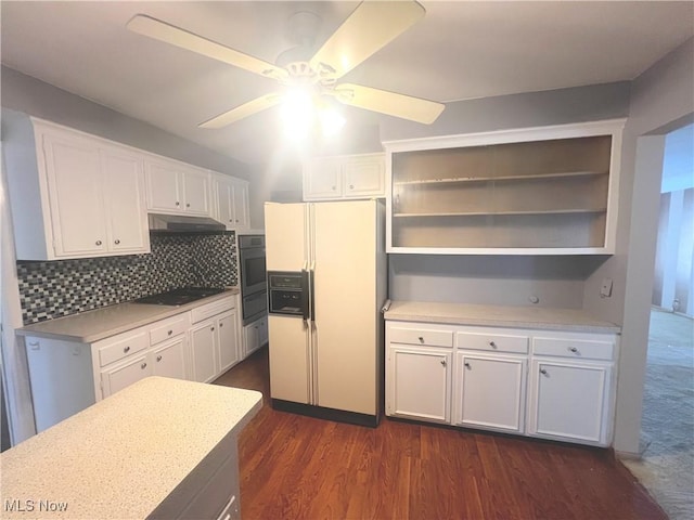 kitchen with white fridge with ice dispenser, black electric stovetop, ceiling fan, white cabinets, and backsplash