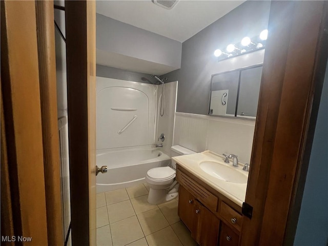 full bathroom featuring toilet, vanity, tile patterned floors, and shower / tub combination