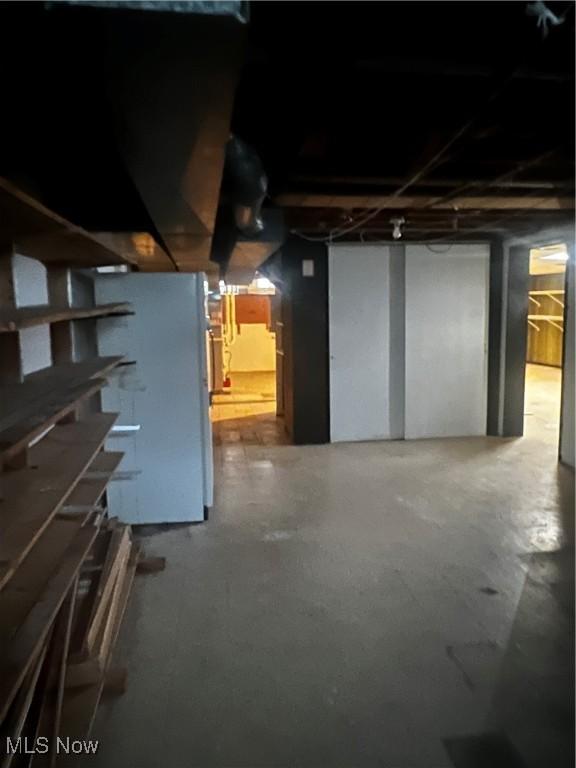 basement featuring white fridge