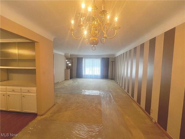 interior space featuring carpet flooring and a chandelier