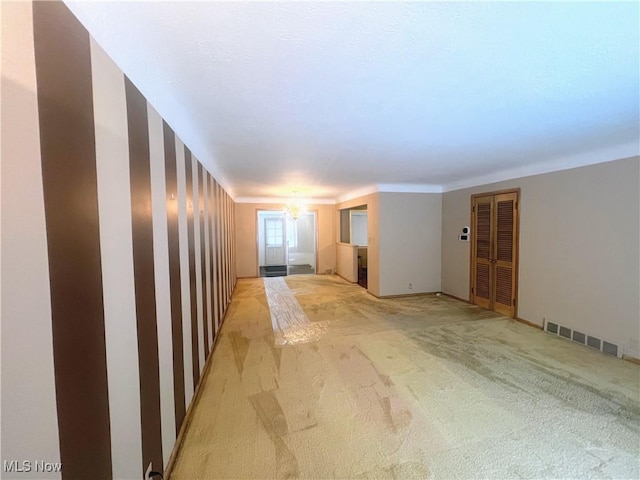 unfurnished room featuring light colored carpet