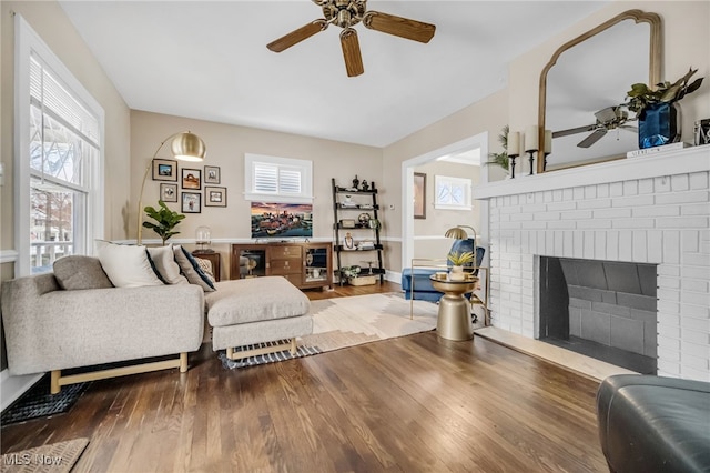 living room featuring a fireplace, ceiling fan, and hardwood / wood-style flooring