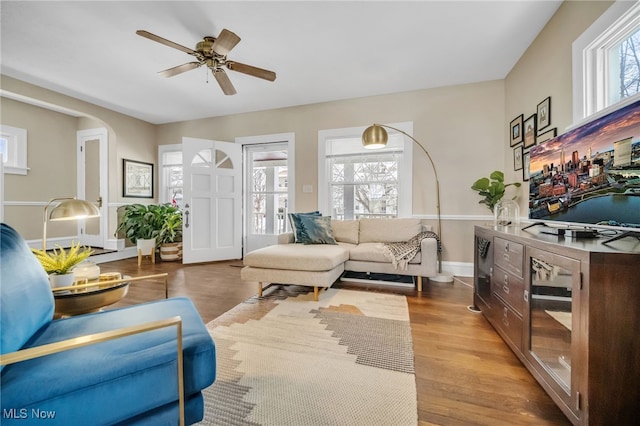 living room featuring ceiling fan and light hardwood / wood-style floors