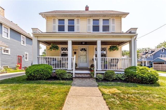 view of front of house featuring a front yard and covered porch