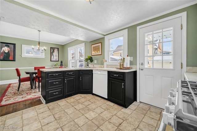 kitchen featuring white dishwasher, decorative light fixtures, a chandelier, and ornamental molding