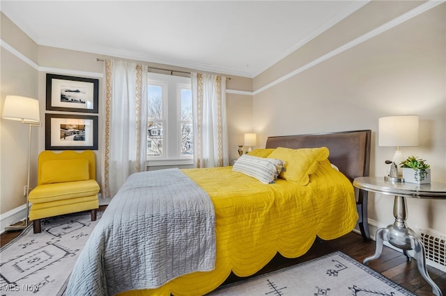 bedroom featuring crown molding and hardwood / wood-style floors