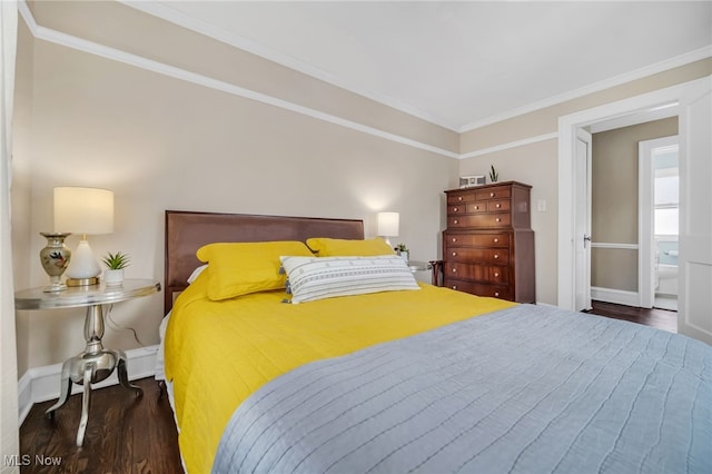 bedroom featuring ensuite bathroom, ornamental molding, and dark hardwood / wood-style floors