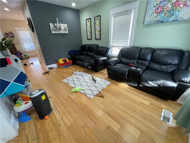 living room with hardwood / wood-style flooring and a wealth of natural light