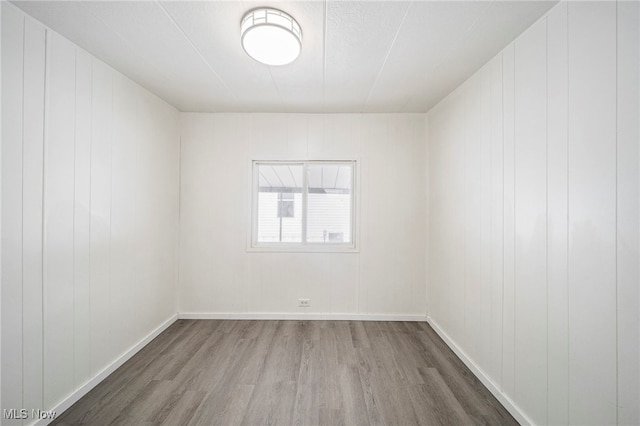 unfurnished room with wood-type flooring