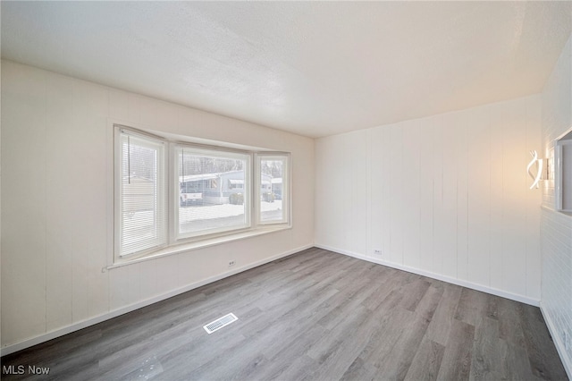 empty room with hardwood / wood-style flooring