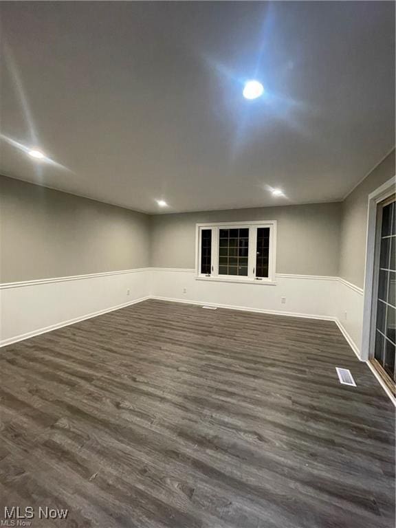 unfurnished room featuring dark wood-type flooring