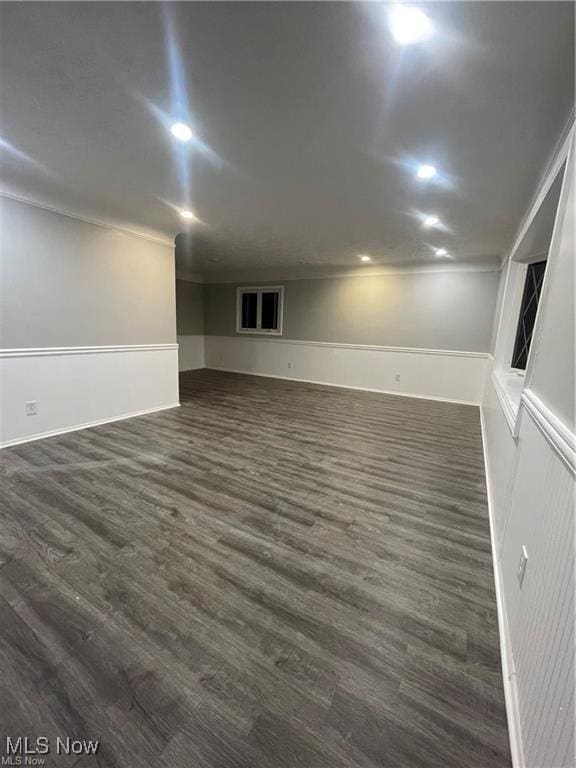 interior space featuring dark wood-type flooring and crown molding