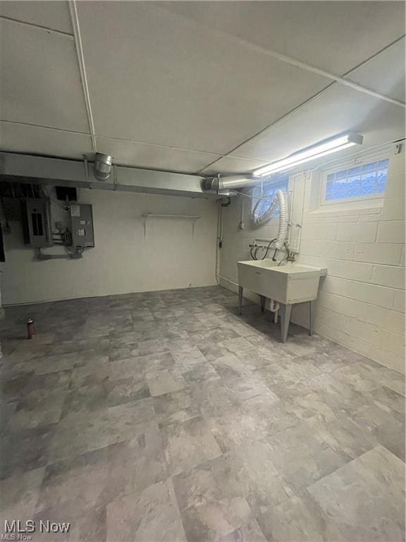 basement featuring sink and electric panel