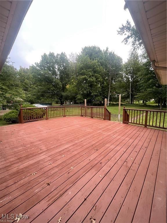 wooden deck with a lawn