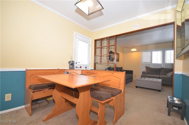 dining space with light colored carpet and ornamental molding