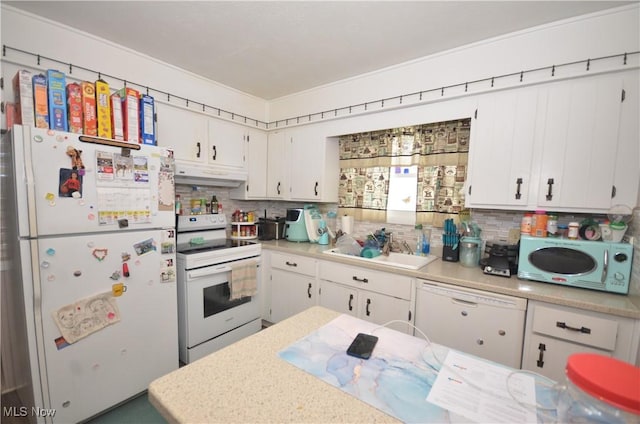 kitchen with white appliances, white cabinetry, decorative backsplash, and sink