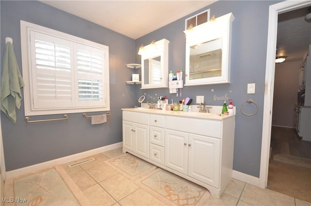 bathroom featuring tile patterned flooring and vanity