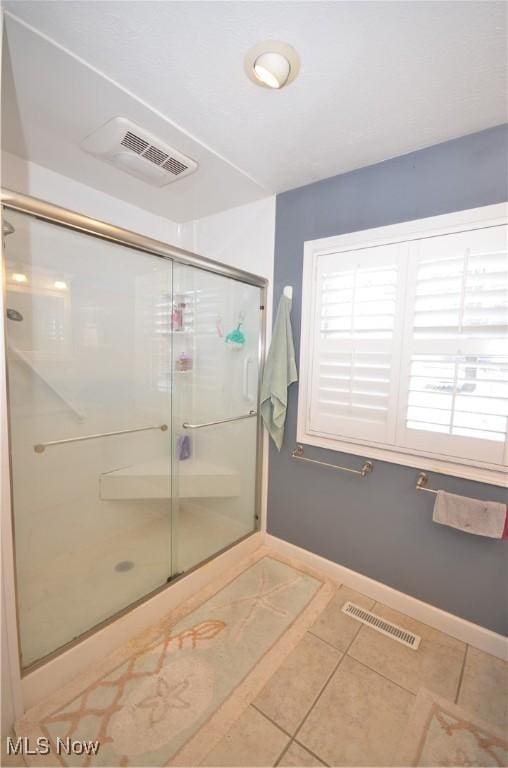 bathroom featuring walk in shower and tile patterned floors