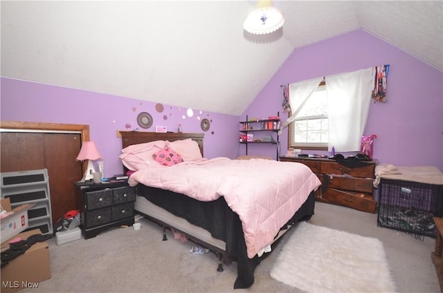 carpeted bedroom with lofted ceiling