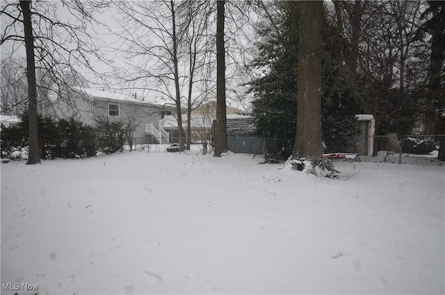 view of yard layered in snow