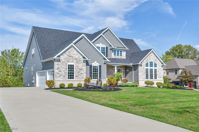 view of front of house with a front lawn and a garage