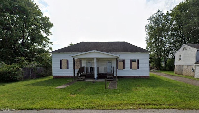 view of front of house with a front yard and covered porch