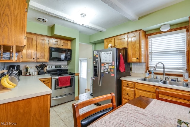 kitchen with stainless steel appliances, sink, light tile patterned floors, tasteful backsplash, and beam ceiling