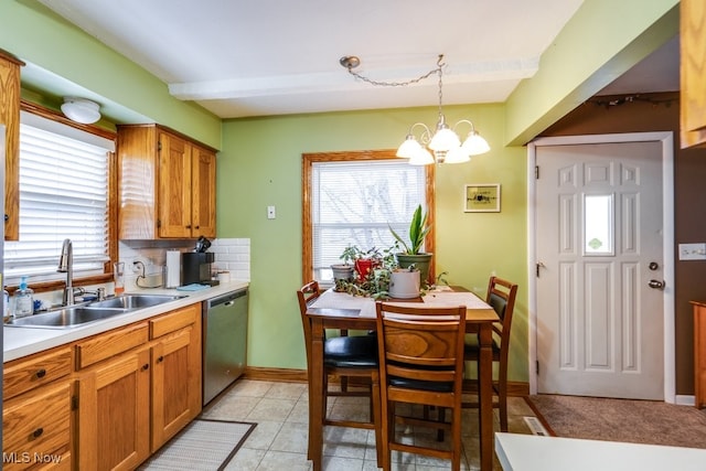 kitchen with dishwasher, a notable chandelier, decorative backsplash, sink, and decorative light fixtures