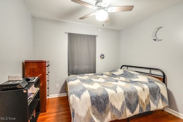 bedroom with ceiling fan and dark hardwood / wood-style floors