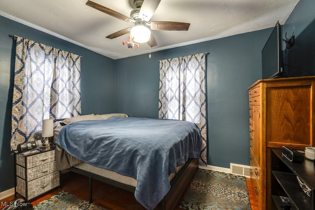 bedroom with ceiling fan and dark hardwood / wood-style floors