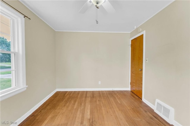 spare room with ceiling fan, light hardwood / wood-style floors, and crown molding