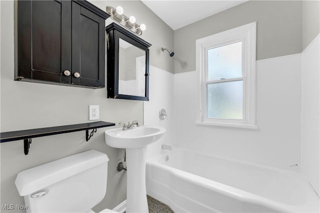 bathroom featuring bathing tub / shower combination and toilet