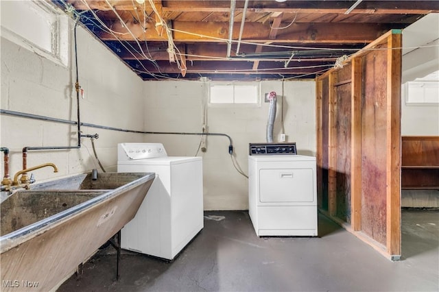 laundry room with separate washer and dryer and sink