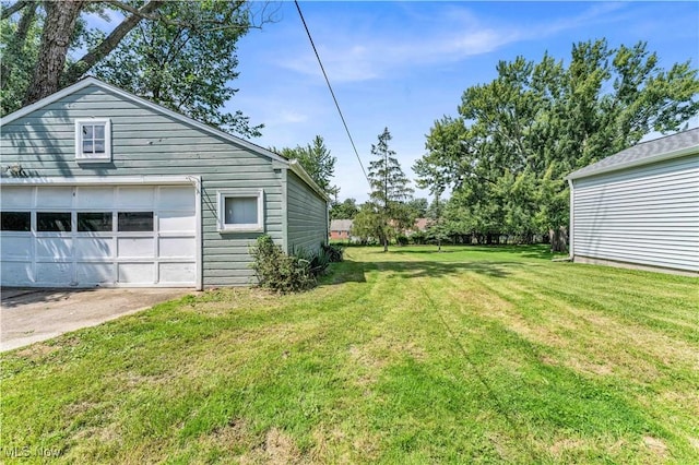 view of yard featuring an outbuilding and a garage